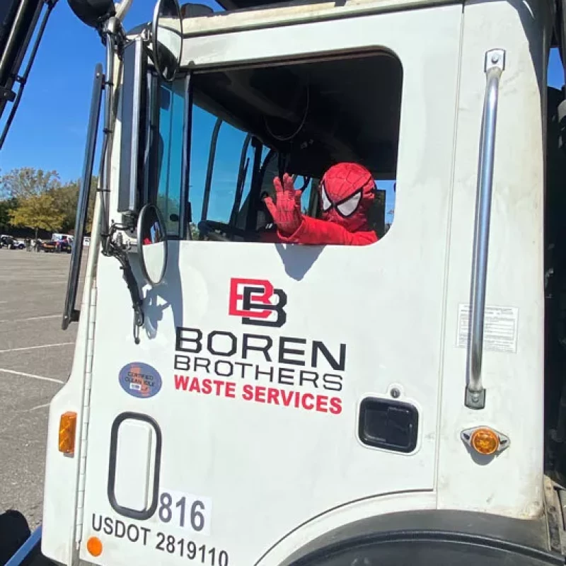 Child In Spider Man Suit sitting in Boren Brothers truck